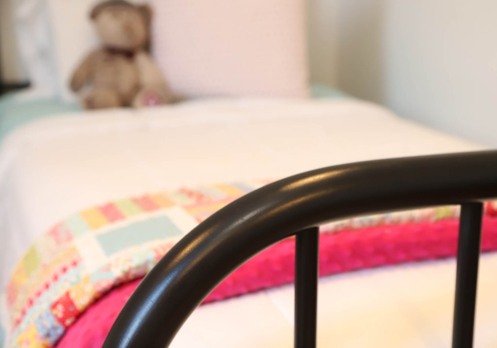 antique metal beds in girls room